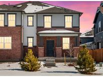 Two-story brick home with a covered porch and landscaping at 235 Mayfly Ln, Berthoud, CO 80513
