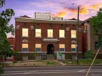 Attractive three-story red brick building with large windows, architectural details and convenient street access at 2524 Champa St # 1, Denver, CO 80205