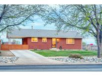 Charming brick home with a well-manicured lawn, long driveway, and a covered carport at 9100 Yucca Way, Thornton, CO 80229
