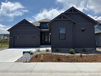 Attractive home featuring a gray exterior, complemented by a two-car garage and tasteful landscaping at 901 Coal Bank Trl, Castle Rock, CO 80104