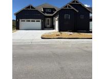Charming single-Gathering home with a white garage door, concrete driveway and professional landscaping at 901 Coal Bank Trl, Castle Rock, CO 80104
