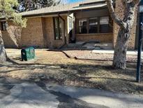 Charming home featuring a brick facade and well-kept yard, showcasing its inviting curb appeal at 8542 W 10Th W Ave, Lakewood, CO 80215
