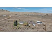 Sprawling property featuring multiple buildings and an RV parking area, surrounded by vast open land at 11810 Mesa View Rd, Larkspur, CO 80118