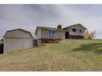 Charming home with stone accents and a spacious shed, perfect for storage and hobbies at 11810 Mesa View Rd, Larkspur, CO 80118