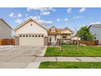 Charming single-Gathering home features a manicured lawn, brick accents, and an attached two-car garage at 4759 Mt Princeton, Brighton, CO 80601