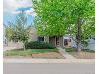 Charming home with a well-manicured front yard featuring mature trees and a sidewalk leading to the front door at 4480 S Pennsylvania St, Englewood, CO 80113