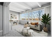 Bright living area with a large window, desk, and comfortable seating at 1888 S Jackson St # 604, Denver, CO 80210