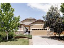 Charming single-Gathering home featuring manicured landscaping, stone accents, and an attached two-car garage at 3972 S Shawnee Way, Aurora, CO 80018