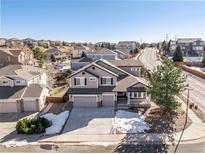 Stunning two-story home with a three-car garage, charming front porch and a well-maintained landscaped yard at 1828 Aquamarine Ct, Castle Rock, CO 80108