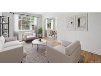 Bright living room with contemporary furnishings, large windows, and an open layout to the dining area at 1130 N Pennsylvania St # 208, Denver, CO 80203