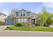 Charming two-story home with a well-manicured lawn, lush landscaping, and a lovely brick facade at 907 Eldorado Dr, Superior, CO 80027