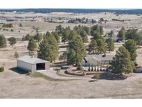 Sprawling property with a home, large storage structure, mature trees and a beautiful landscape in a serene, rural setting at 2287 Pinto Trl, Elizabeth, CO 80107