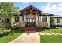 Inviting home entrance features wood columns, stone accents, and a rustic antler decoration above the front door at 3720 Ranch Hand Ln, Castle Rock, CO 80104