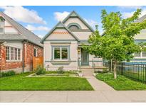 Charming home with a well-maintained lawn, attractive trim, and a cute tree in the front yard at 3613 Julian St, Denver, CO 80211