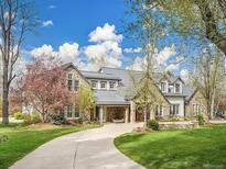 Stunning stone home with a curved driveway and meticulous landscaping at 1075 E Oxford Ln, Cherry Hills Village, CO 80113