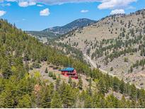 Secluded home nestled within a forest with mountain views at 5896 Peregrine Trl, Golden, CO 80403