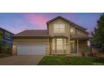 Charming home featuring a two-car garage and a well-manicured lawn at 19259 E Caspian Pl, Aurora, CO 80013
