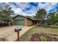 Charming brick home boasts a well-manicured front yard, mature trees, and a convenient two-car garage, creating curb appeal at 3722 Monterey Pl, Boulder, CO 80301