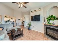 Bright living room with hardwood floors, fireplace, and large windows at 5694 N Gibralter Way # 305, Aurora, CO 80019