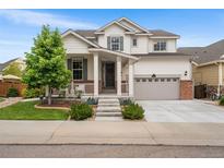 Charming two-story home with a well-maintained front yard, covered porch, and a two-car garage in a suburban neighborhood at 2679 Leafdale Cir, Castle Rock, CO 80109