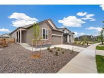 Beautiful single-Gathering home boasting stone accents, a two-car garage and well-maintained landscaping at 9313 Biscay St, Commerce City, CO 80022