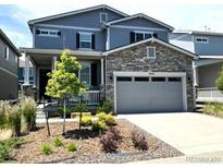 Beautiful two-story home featuring stone accents, an attached two-car garage, and a well-maintained front yard at 3945 John Ave, Castle Rock, CO 80104