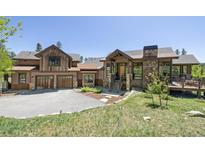 Inviting exterior with wooden accents, stone details, and a well-manicured lawn at 41 Barton Ridge Dr, Breckenridge, CO 80424