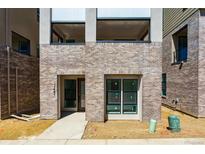 New construction featuring modern brick facade, sizable windows, and second story balconies at 11481 E Briarwood Cir, Centennial, CO 80112