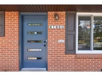 Stylish blue front door with modern window accents and brick facade at 8100 W 8Th Ave, Lakewood, CO 80214