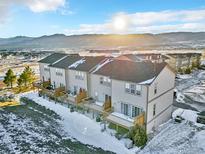 Aerial view of three-story townhouses with private decks and mountain views at 909 Burning Bush Pt, Monument, CO 80132