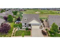 Beautiful home with landscaped front yard and a view of the golf course at 5280 Genoa St, Denver, CO 80249