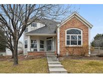 Charming two-story home with a brick facade and a welcoming front porch and well maintained yard at 1011 S Valentia St # 43, Denver, CO 80247
