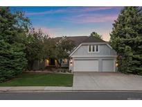 Beautiful two-story home featuring a two-car garage and well-manicured lawn at 5227 S Geneva St, Englewood, CO 80111