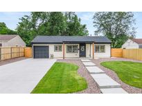 Charming single story home with well-manicured lawn, walkway, garage and neutral exterior at 3061 S Glencoe St, Denver, CO 80222