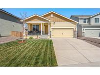 Charming single-Gathering home featuring a well-manicured lawn and inviting front porch at 47385 Lily Ave, Bennett, CO 80102