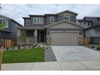 Charming two-story home featuring a two-car garage, welcoming porch, and well-maintained front yard and landscaping at 1290 Loraine N Cir, Lafayette, CO 80026