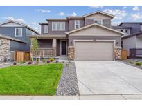 Charming two-story home featuring a well-manicured lawn, covered porch, and an attached two-car garage at 1290 Loraine N Cir, Lafayette, CO 80026