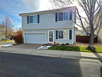 Two-story townhome with attached garage and landscaping at 20000 Mitchell Pl # 37, Denver, CO 80249