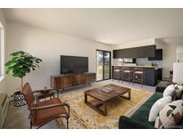 Comfortable living room that opens to kitchen, with carpet, stylish furniture, and sliding doors to a patio at 645 Manhattan Pl # 106, Boulder, CO 80303
