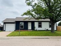 Charming single Gathering home boasts a well manicured front yard and an attached garage at 4312 S Xenon St, Morrison, CO 80465