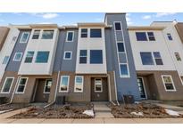 Attractive townhome with a brick facade and blue and white siding at 14265 Currant St, Broomfield, CO 80020