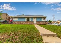Charming single-story home featuring stone accents, a well-manicured lawn, and a classic white front door at 5001 W Nevada Pl, Denver, CO 80219