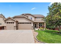 Charming two-story home featuring a three-car garage, well-maintained lawn and mature landscaping at 12942 Leyden St, Thornton, CO 80602