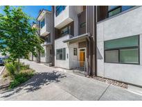 Modern townhome featuring clean architectural lines, a yellow front door, and convenient street-side access at 2893 W 10Th Ave, Denver, CO 80204