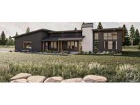 Modern home boasts a clean, contemporary design with striking curb appeal, complete with verdant lawn and rock landscaping at 65960 E Evans Pl, Byers, CO 80103