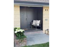 Inviting front entry with a bench and charming flower planter adding curb appeal to this home at 85 S Flower St, Lakewood, CO 80226