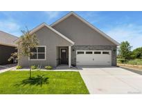 Charming single-story home with stone accents, a well-maintained lawn, and a two-car garage at 311 Josef Cir, Fort Lupton, CO 80621