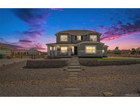 Charming two-story home with front porch and landscaped front yard, perfect curb appeal at 4532 Dewey Ln, Brighton, CO 80603