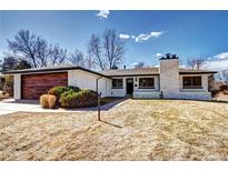 Charming single-story home boasts a brick facade, mature landscaping, and a detached two-car garage at 507 S Pontiac Way, Denver, CO 80224