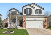 Charming two-story home with a well-manicured lawn, attached two-car garage, and attractive curb appeal at 398 Benton St, Castle Rock, CO 80104